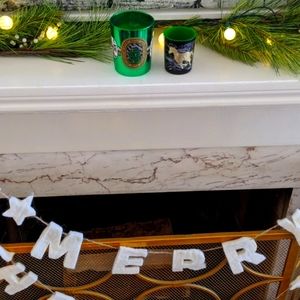 Two limited edition Diptyque holiday candles